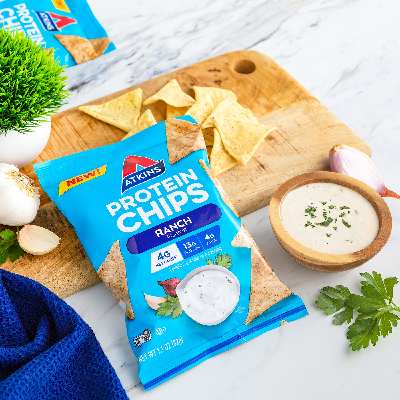 Ranch Snack Protein Chips with ranch dressing, chopping board, blue cloth on marble table