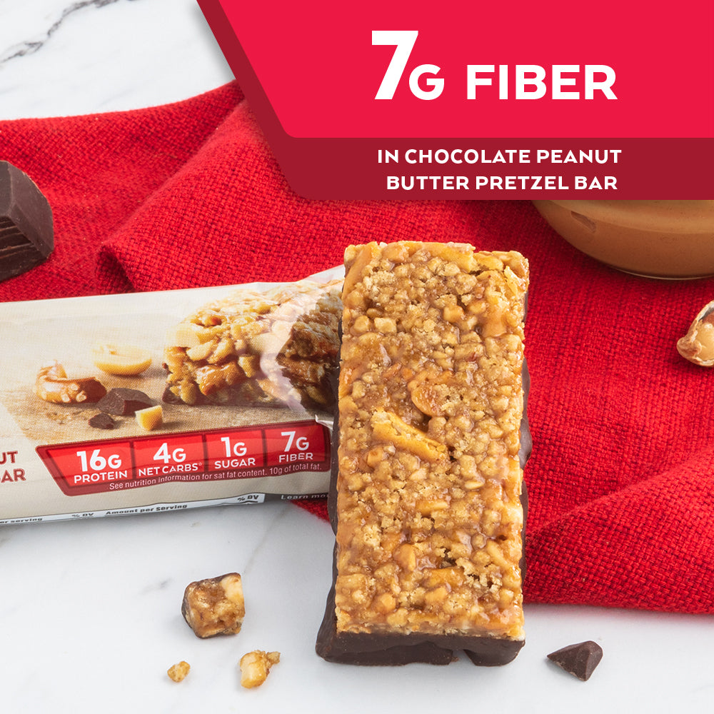 Chocolate Peanut Butter Pretzel Bar with peanut butter, red cloth on marble table; 7G Fiber in vanilla caramel pretzel bar